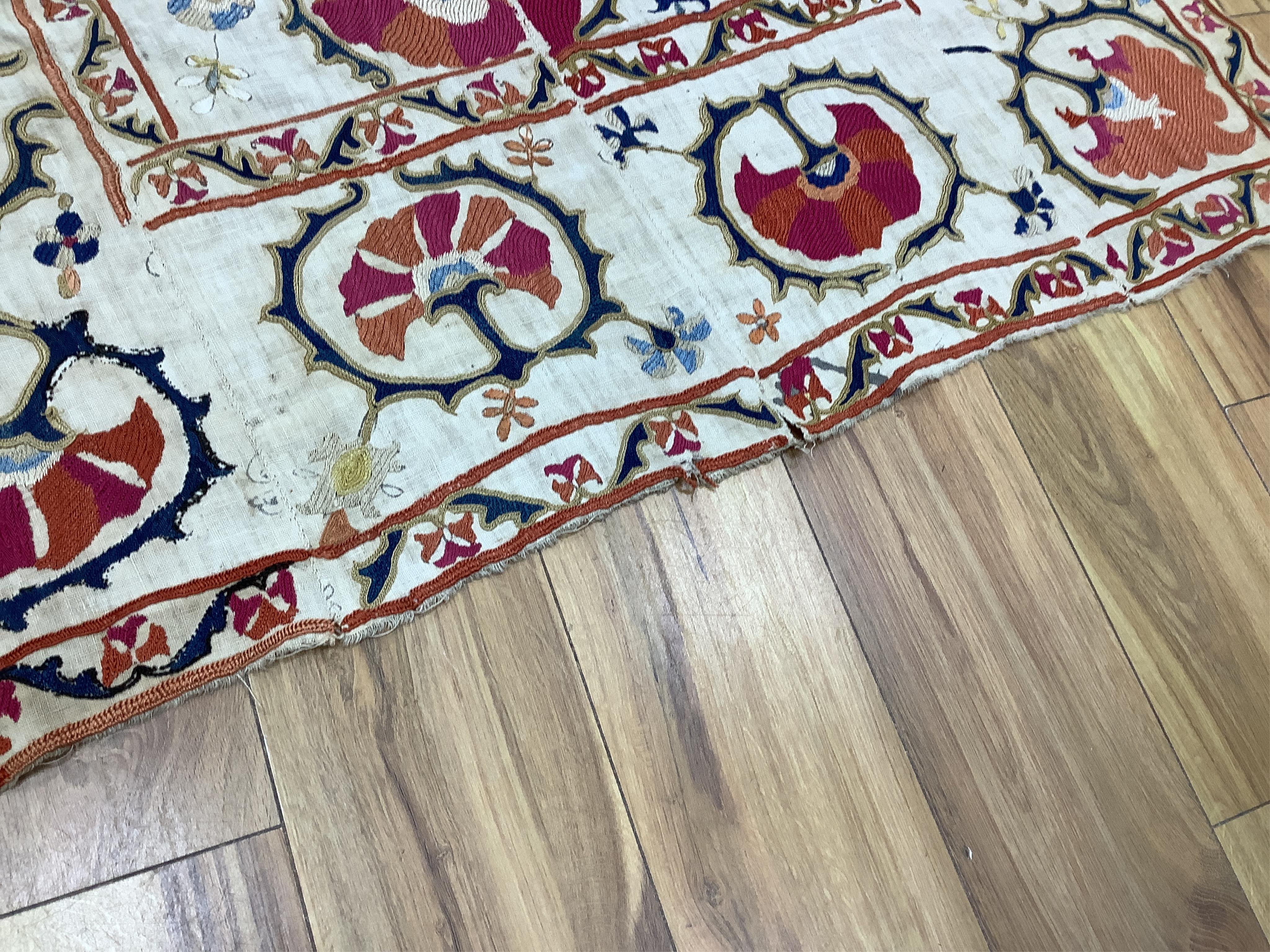 A 19th century Uzbekistan Suzani, hand embroidered hanging. Made from hand woven linen panels each approximately 28cm wide x 167cm long. Hand embroidered with silk hand dyed threads, in orange, red, blue and yellows, usi